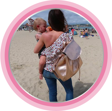 Parent and baby having fun on beach.